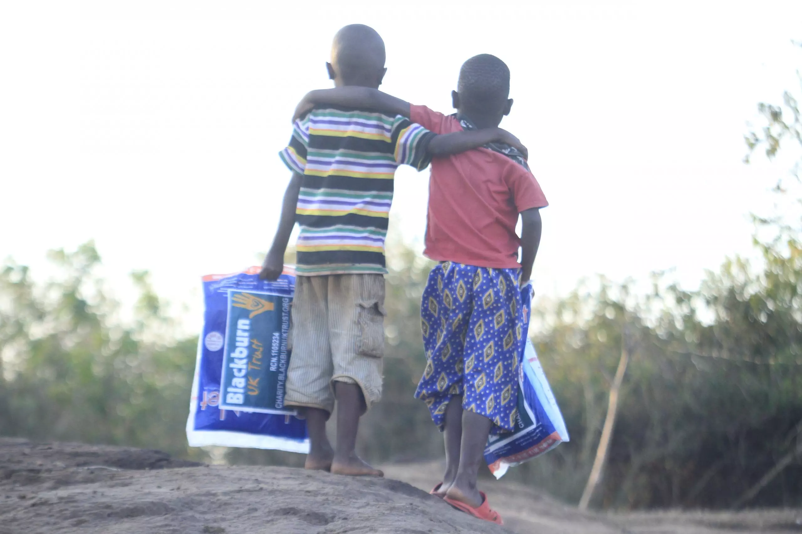 Two children walking together in Tanzania