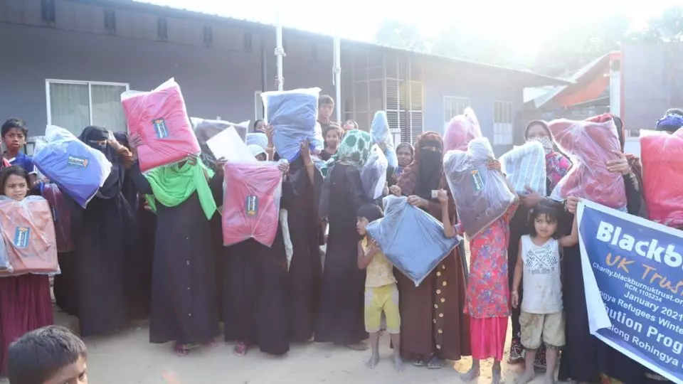 People holding protest signs in Uganda